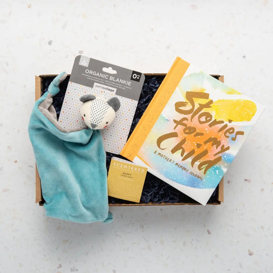 A gift box containing a blue baby blanket, a white bear-shaped plush toy, a happy scentered balm and a colorful gift card.