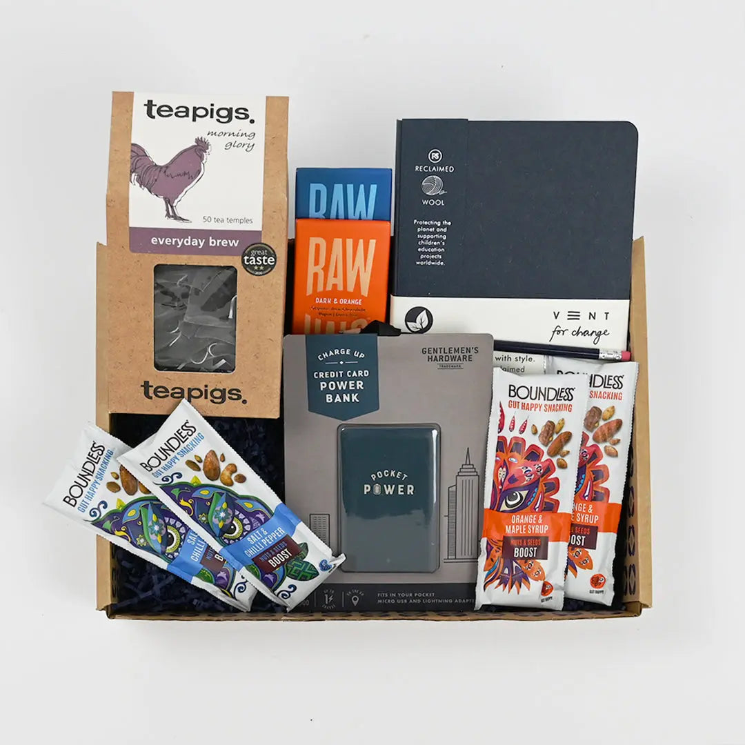 Men's Goodie Box including snacks, a notebook, and a power bank, with branding visible on the packages and containers.