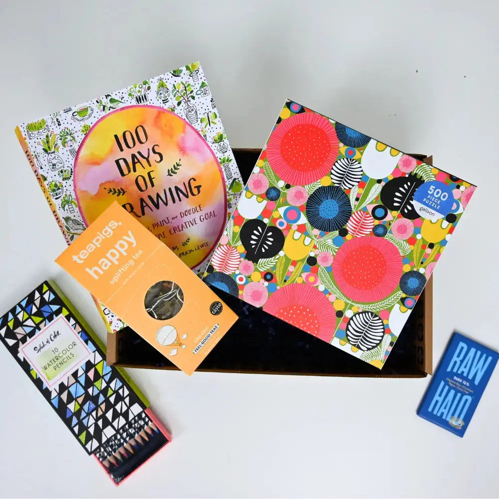 Collection of colorful books and a box on a white background