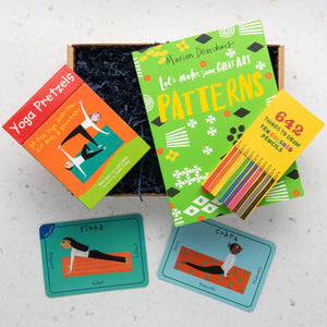 A gift box containing various children's books and activity cards focused on mindfulness and yoga.