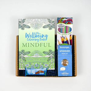 Wellbeing Colouring Care Package containing a wellbeing coloring book titled 'MINDFUL', various colored pencils, and a box of tea.